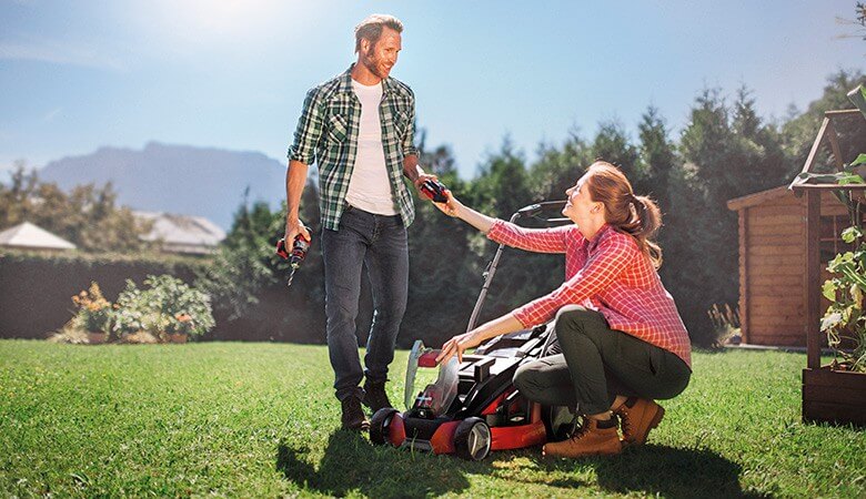 Woman giving a battery to a man